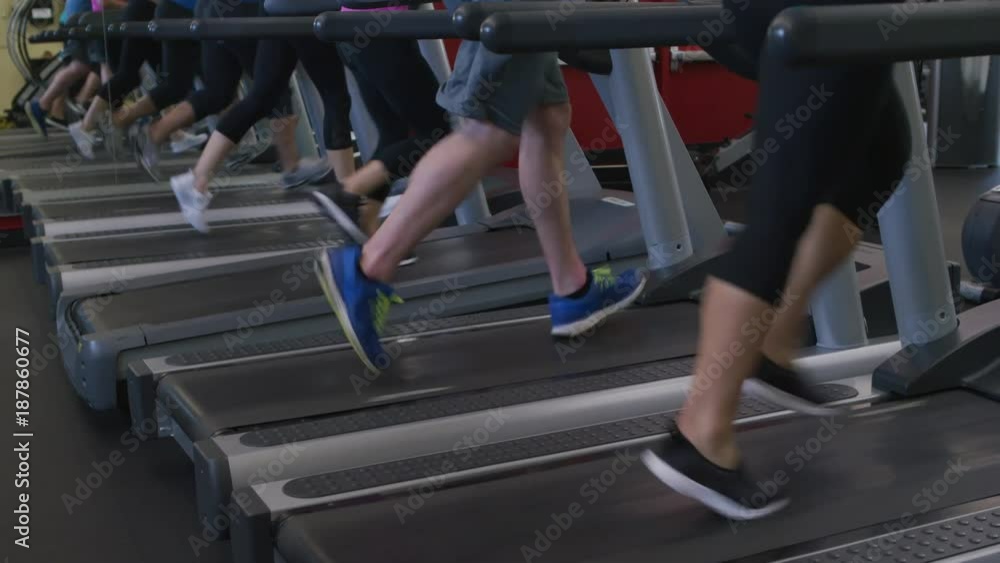Closeup of feet running on treadmills at gym Closeup of feet running on treadmills at gym