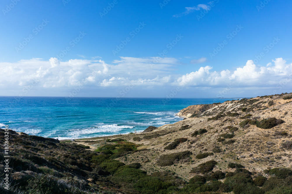 Photo of sea, cloudy sky and hilly slope