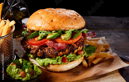 Large gourmet burger with avocado and guacamole