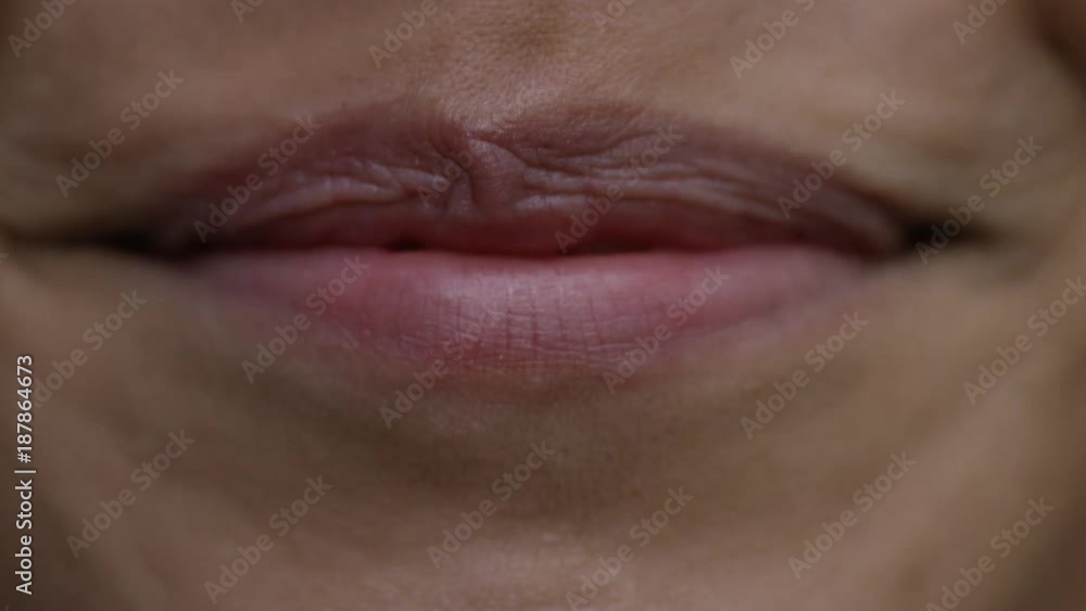 Close up of female lips smiling to camera Close up of female lips smiling to camera