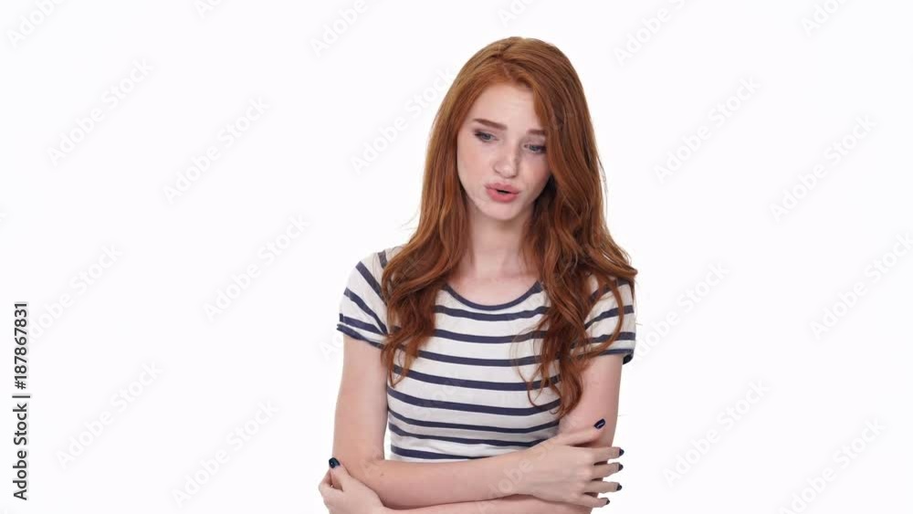 Confused redhead young lady isolated over white wall background talking with you
Confused redhead young lady isolated over white wall background talking with you
