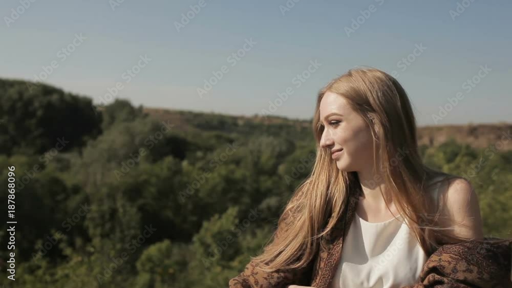 A young girl stands in the background of nature A young girl stands in the background of nature