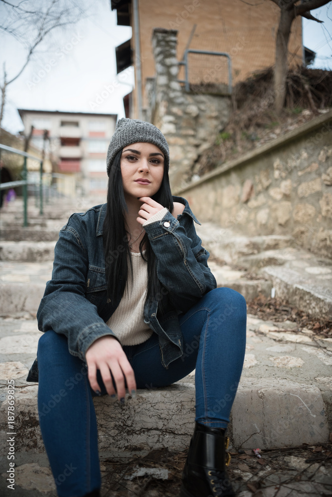 young woman sitting on steps outdoor 