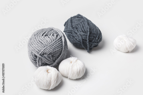 grey and white yarn balls isolated on white