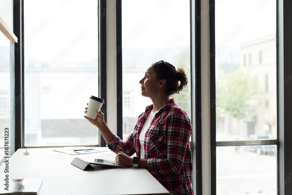 Female executive having cup of coffee in office Female executive having cup of coffee in office