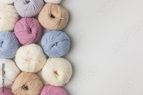 colored yarn balls in a row isolated on white background Fototapeta