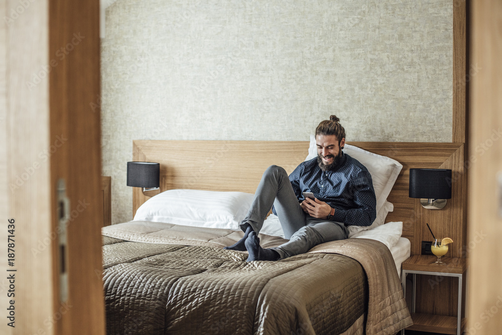Businessman Enjoying on Hotel Bed