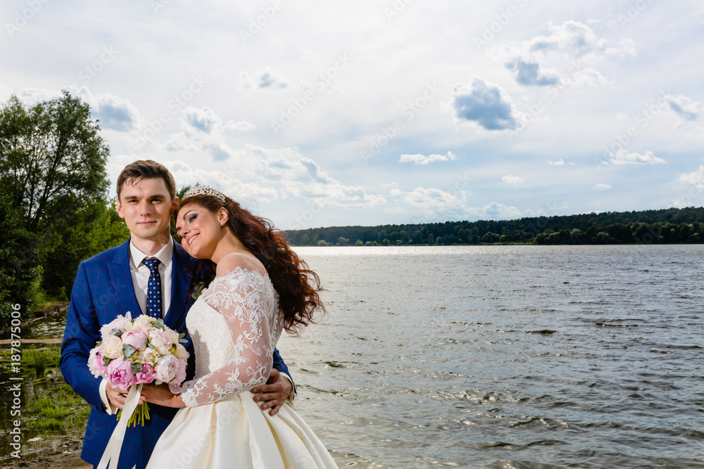 Beautiful couple newlyweds near the lake Beautiful couple newlyweds near the lake