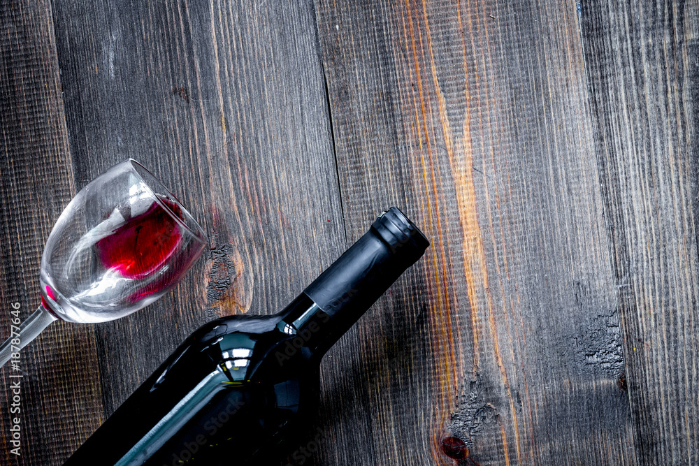 Wine glasses and bottle on dark wooden table background top view