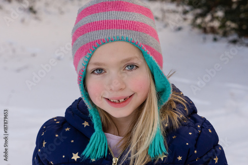 adorable school age girl smiling outside in wintertime 