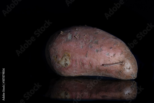 close up of sweet potato with black background