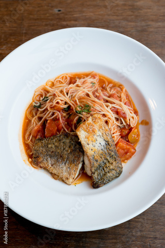 Grilled sea bass and spaghetti with tomato sauce
