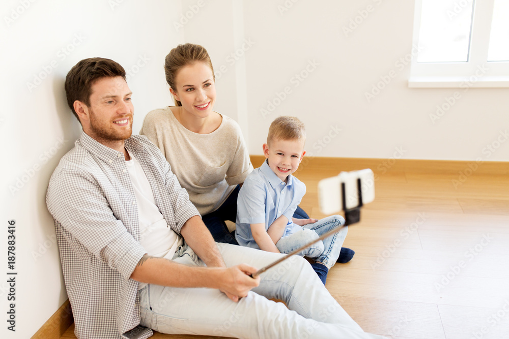 family taking selfie by smartphone at new home family taking selfie by smartphone at new home