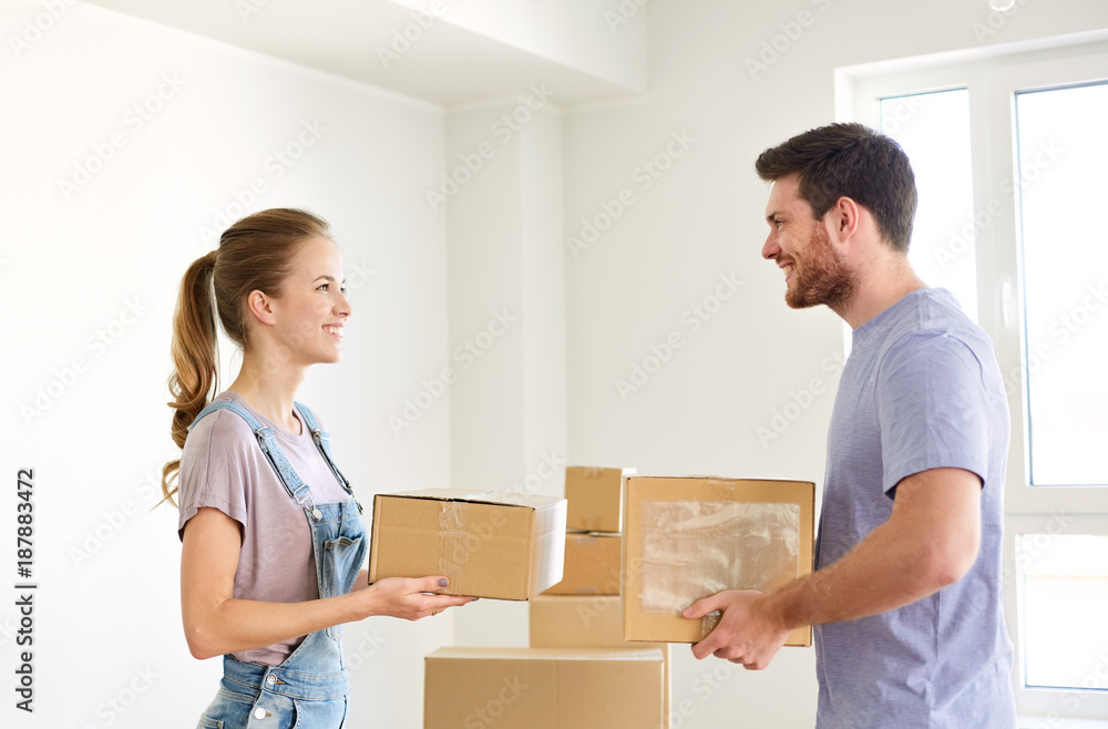 happy couple with boxes moving to new home happy couple with boxes moving to new home