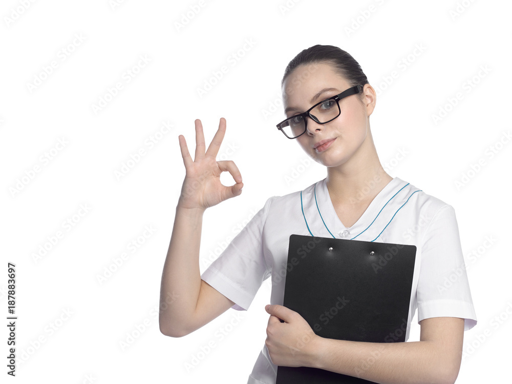 Portrait of a beautiful female student in a medical suit wearing glasses with a black folder. Portrait of a beautiful female student in a medical suit wearing glasses with a black folder.