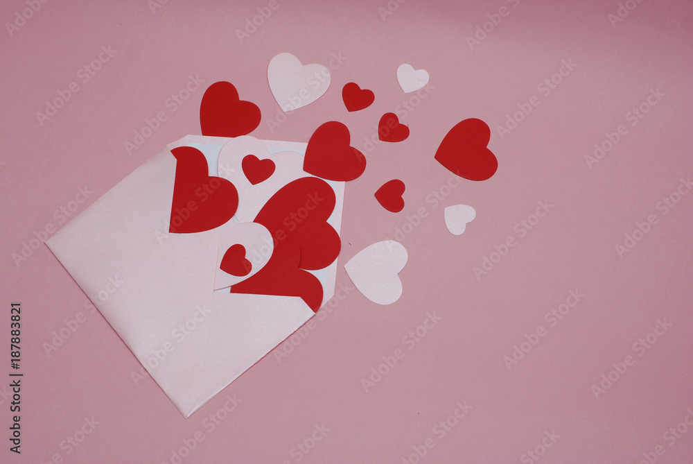 Love letter with paper hearts and Pink Envelope on Pink background