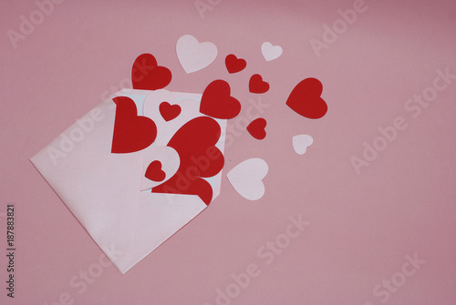 Love letter with paper hearts and Pink Envelope on Pink background