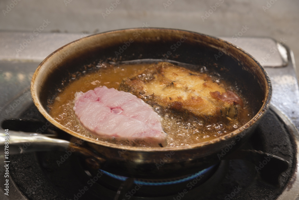 Preparing fried grouper fish in the kitchen Preparing fried grouper fish in the kitchen