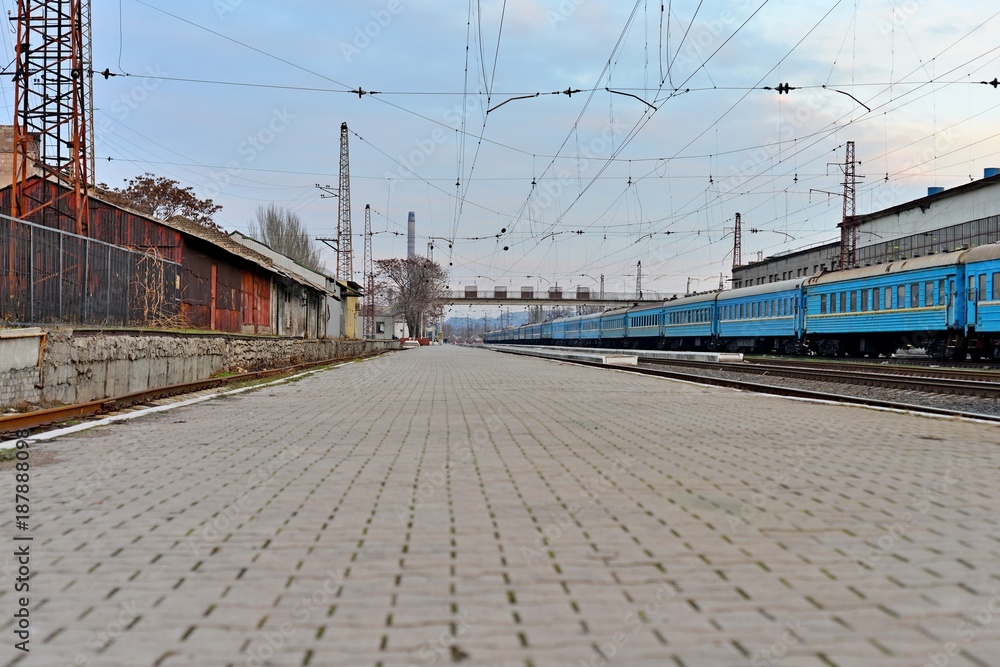 Railway station against beautiful sky at sunset. Industrial landscape with railroad, colorful cloudy blue sky. Railway sleepers. Railway junction. Heavy industry. Cargo shipping. Travel background Railway station against beautiful sky at sunset. Industrial landscape with railroad, colorful cloudy blue sky. Railway sleepers. Railway junction. Heavy industry. Cargo shipping. Travel background