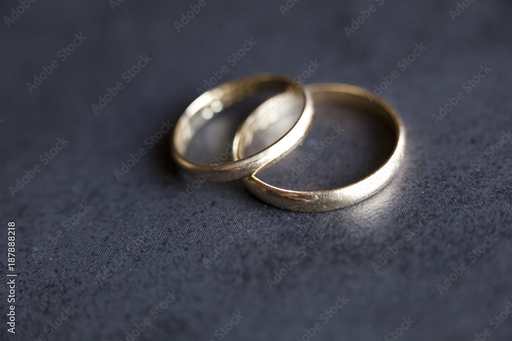 Gold wedding rings on dark background Gold wedding rings on dark background