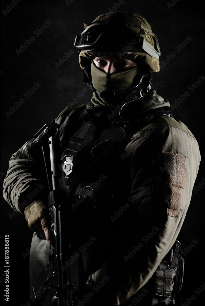 The man in the image of a member of the SWAT police with weapons The man in the image of a member of the SWAT police with weapons
