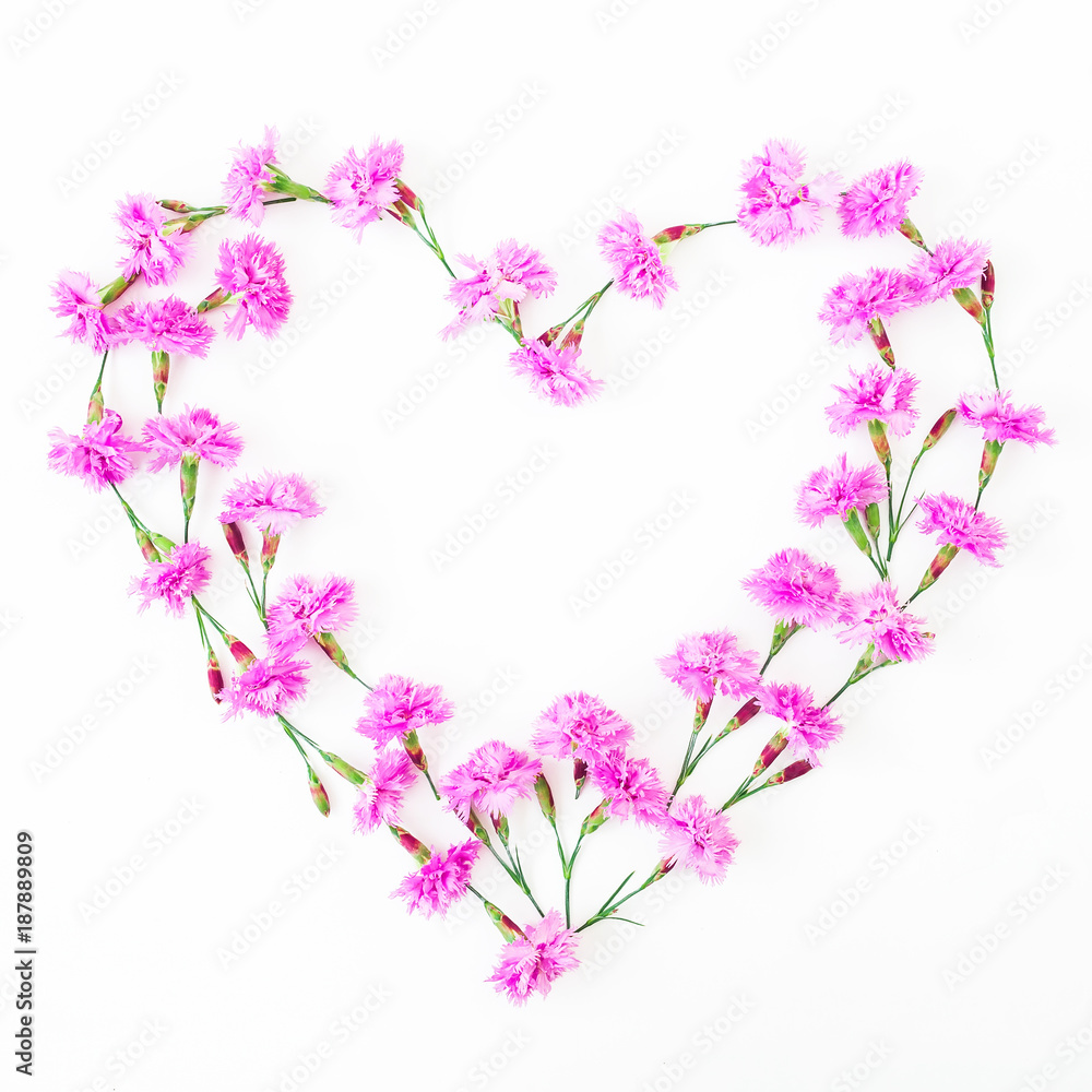 Heart of pink flowers on white background. Flat lay, top view. Valentine's day. 