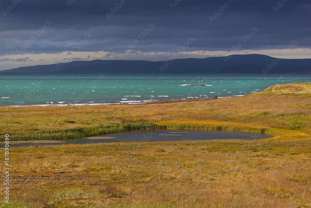 Impressive view of the stormy Barents sea in cloudy weather, short summer in Finnmark, Norway. Northernmost part of continental Europe Impressive view of the stormy Barents sea in cloudy weather, short summer in Finnmark, Norway. Northernmost part of continental Europe