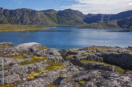 Magnificent mountain lake with the coast covered with moss. Short summer in Finnmark, Norway. Northernmost part of continental Europe