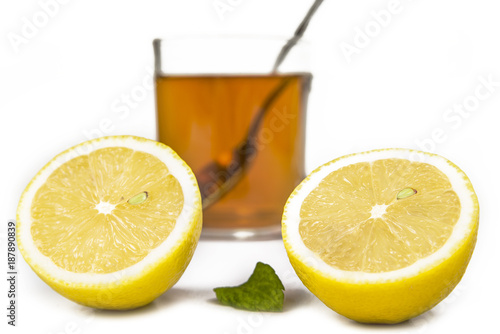 Lemon and cup of tea with mint leaf