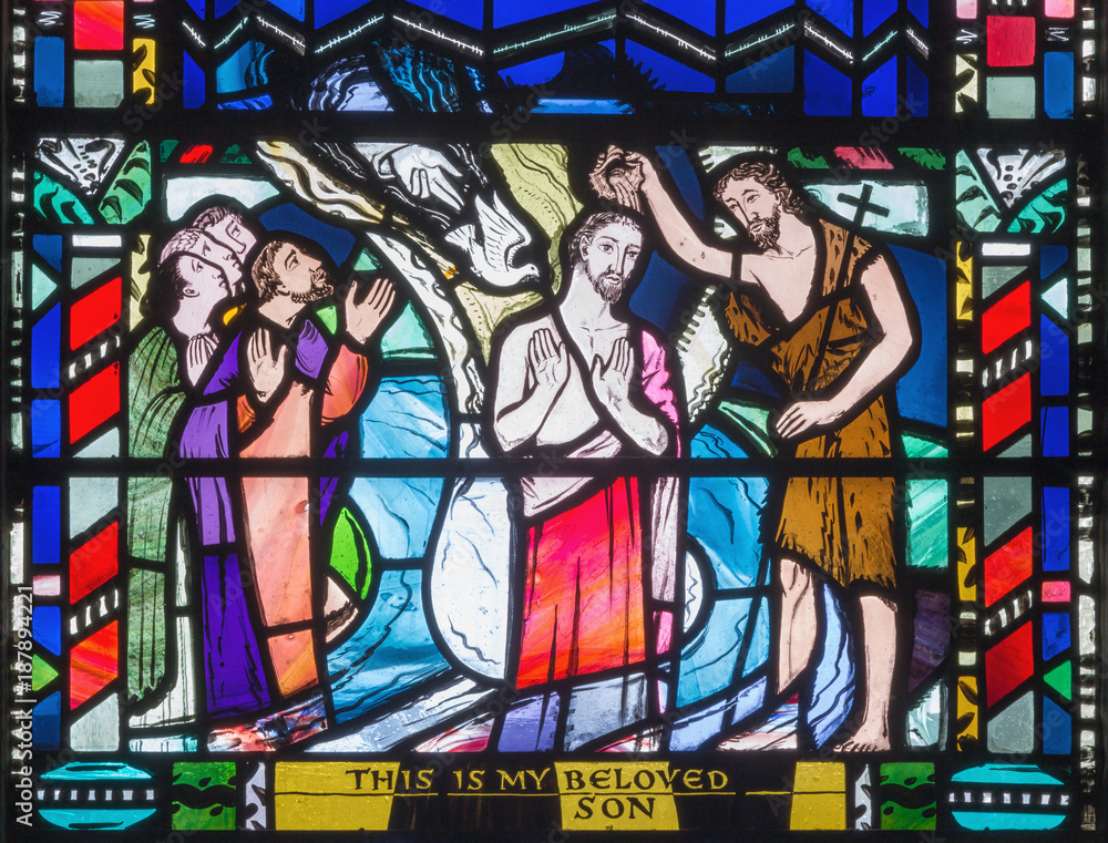 LONDON, GREAT BRITAIN - SEPTEMBER 16, 2017: The Babtism of Jesus cene on the stained glass in church St Etheldreda by Charles Blakeman (1953 - 1953).