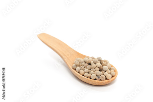 Pile of pepper on wooden spoon isolated on white background