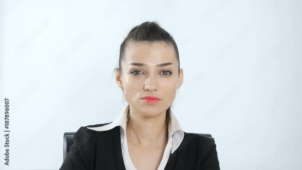 Young, beautiful girl looking at the camera with a serious face, White background 60 fps Young, beautiful girl looking at the camera with a serious face, White background 60 fps