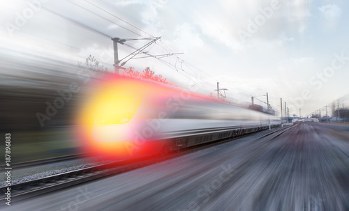 High speed train runs on rail tracks . Train in motion. © muratart
