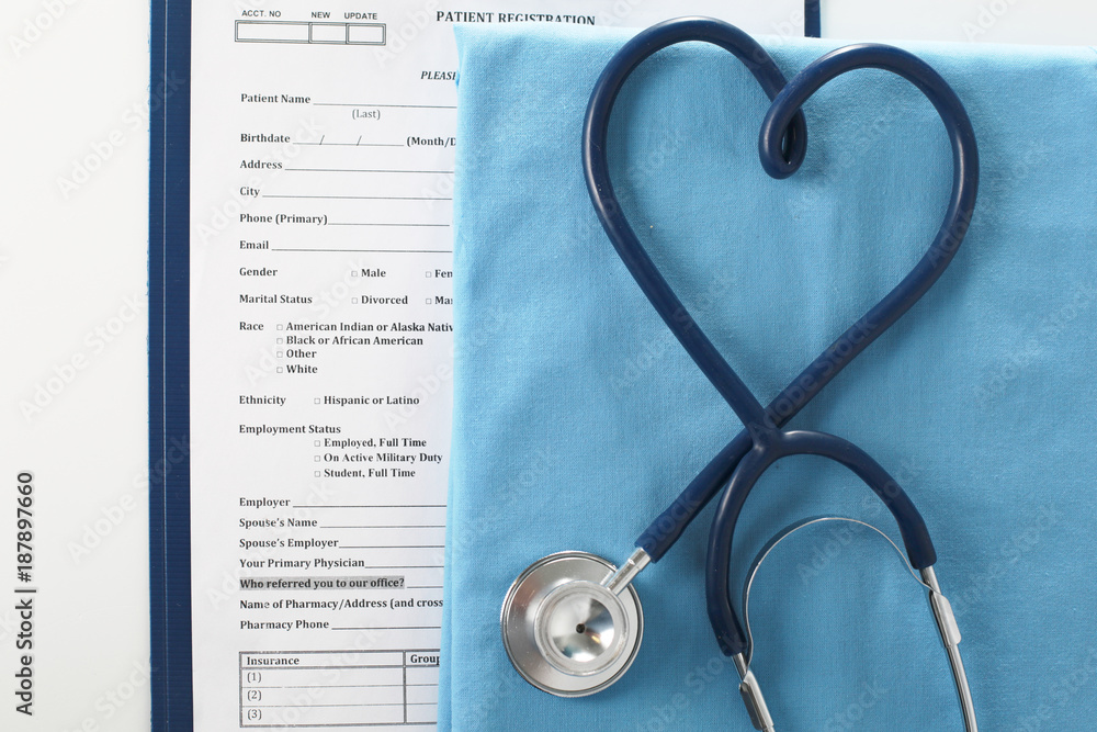 Stethoscope on a table with medical uniform Stethoscope on a table with medical uniform