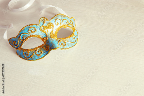 Image of delicate blue elegant venetian mask white background.