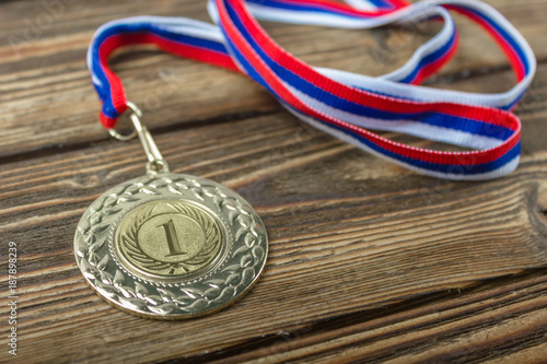 Gold medal on a wooden background.