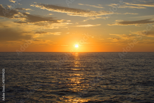 Magnificent setting sun centered over ocean © Shakzu