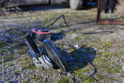 worker use circular saw to cut surface racetrack in stadium (remove surface race track for repair and change surface racetrack) photo