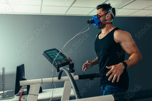 Fitness man running on treadmill testing his performance