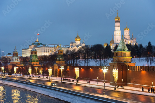 The Moscow Kremlin in the winter night and the Moskva River embankment with a Christmas decoration