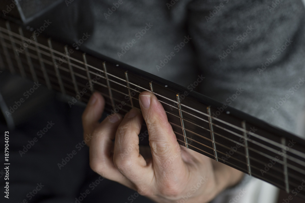 Fototapeta premium Elderly man playing carbon fiber guitar