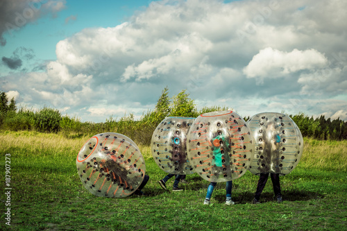 Bumperball. Teens play bumper-ball outdoor