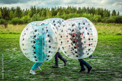 Bumperball. Teens play bumper-ball outdoor