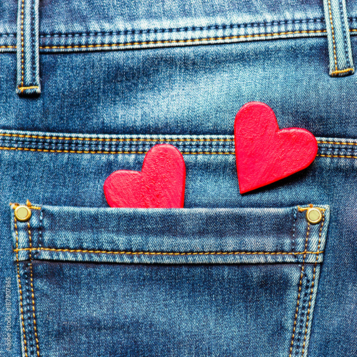 two hearts on a background of a jeans pocket close-up.Valentines Day background consept.