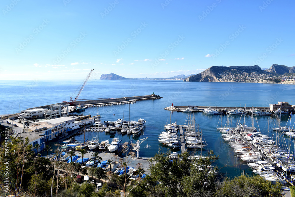 Beautiful view on Calpe town and harbor with sea boats and mountains, Spain, Costa Blanca