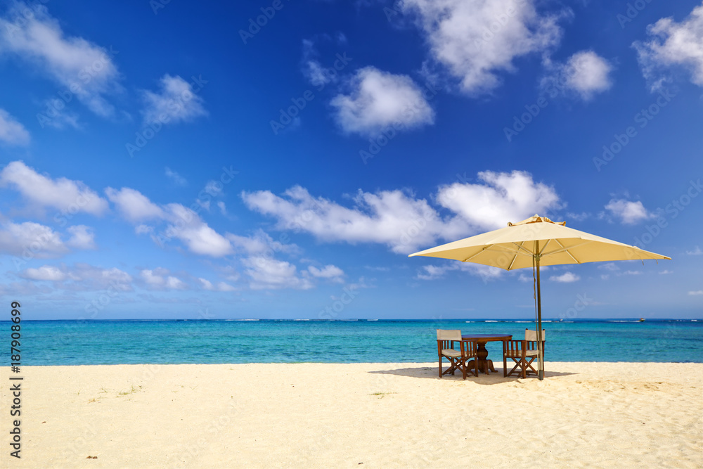 Table, chairs and umbrella on sand beach in Mauritius Island Table, chairs and umbrella on sand beach in Mauritius Island