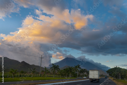 Sunset on highway with view of volcanoes Fuego y Acatenango in Palin, Guatemala.