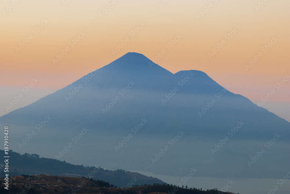 Panoramic view at dawn of volcano atitlan, from road, dramatic colorful, rural landscape of Guatemala.