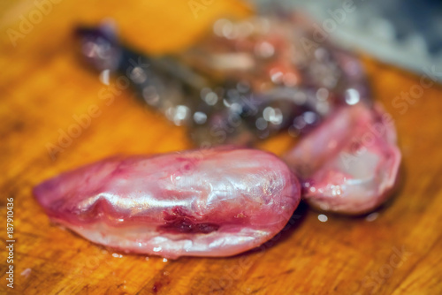 Swim bladder covered in blood on table close photo