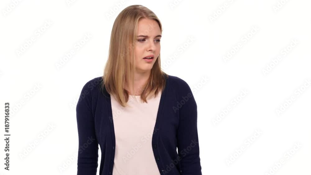 Confused blonde woman in cardigan coughs and looking at the camera over white background
Confused blonde woman in cardigan coughs and looking at the camera over white background